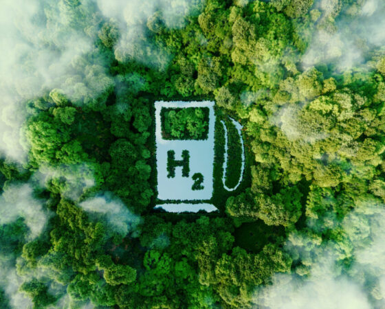 A lake in the shape of a hydrogen filling station used as a concept to illustrate the environmental friendliness of hydrogen and its potential as the fuel of the future. 3d rendering.